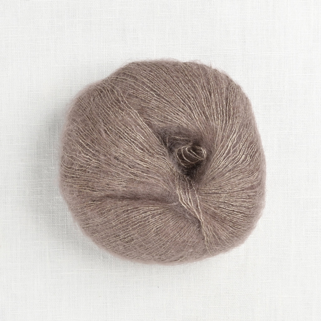 Ball of brown yarn on a white background